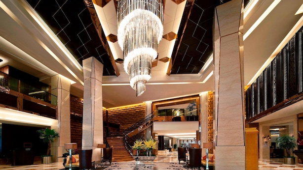 A spacious lobby with a grand chandelier, a staircase, and a checkered floor. - Sheraton Xi'an North City Hotel (Xi'an)