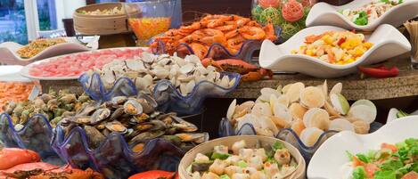 A buffet with various seafood options including shrimp, crab, and clams.