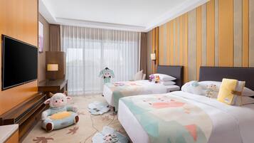 A hotel room with two beds, a TV, a sofa, and a large window with curtains.