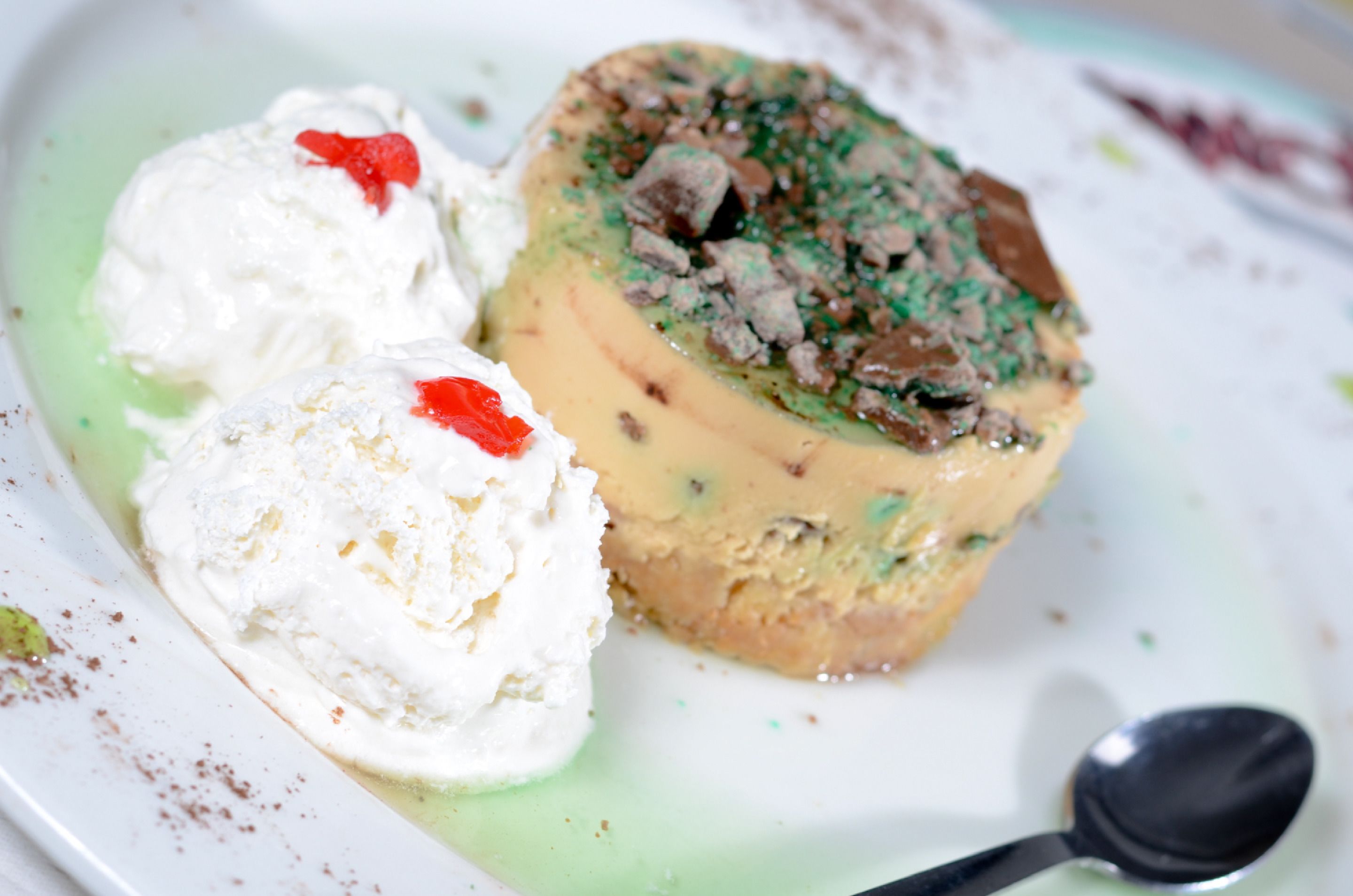 A dessert plate with a layered cake and two scoops of ice cream.