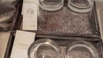 A tray with two glass jars and two boxes labeled "Cotton Buds" and "Shower Cap".