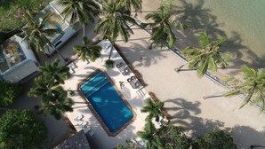 An aerial view of a resort with a swimming pool, beach area, and palm trees. - Lime & Soda Beachfront Resort (Ko Pha-ngan)