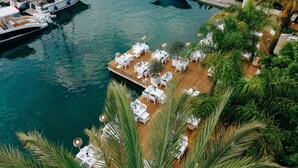 An aerial view of a waterfront restaurant with outdoor seating and a dock.
