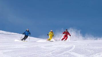 Three skiers on a snow-covered slope.