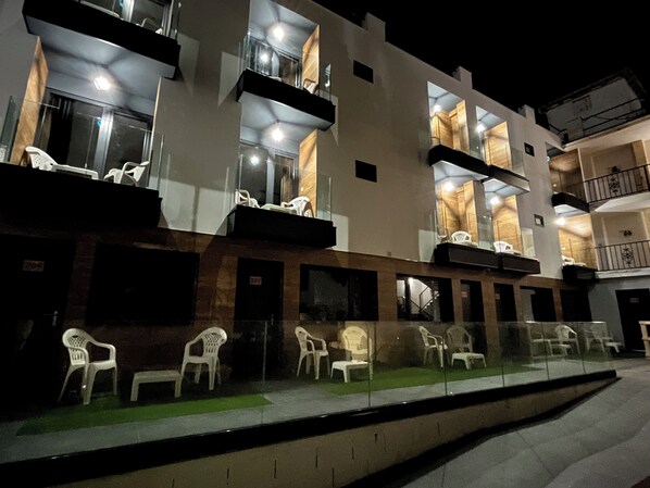 A multi-story building with outdoor seating and a glass railing. - New "Villa Albero" Boutique (Torremolinos)