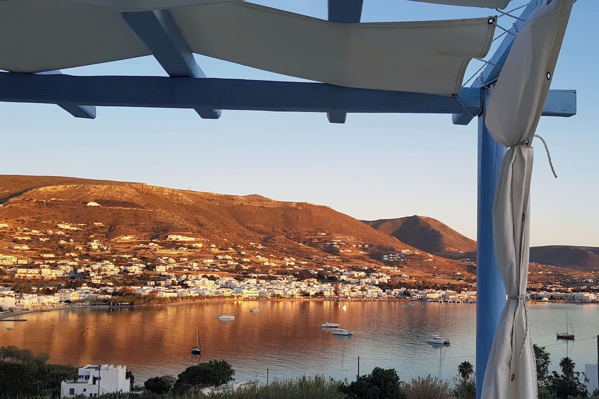A coastal town with a view of the sea and mountains.