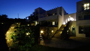 A modern two-story building with a stone staircase leading to the entrance. - Paros Paradise Apartments (Paros)