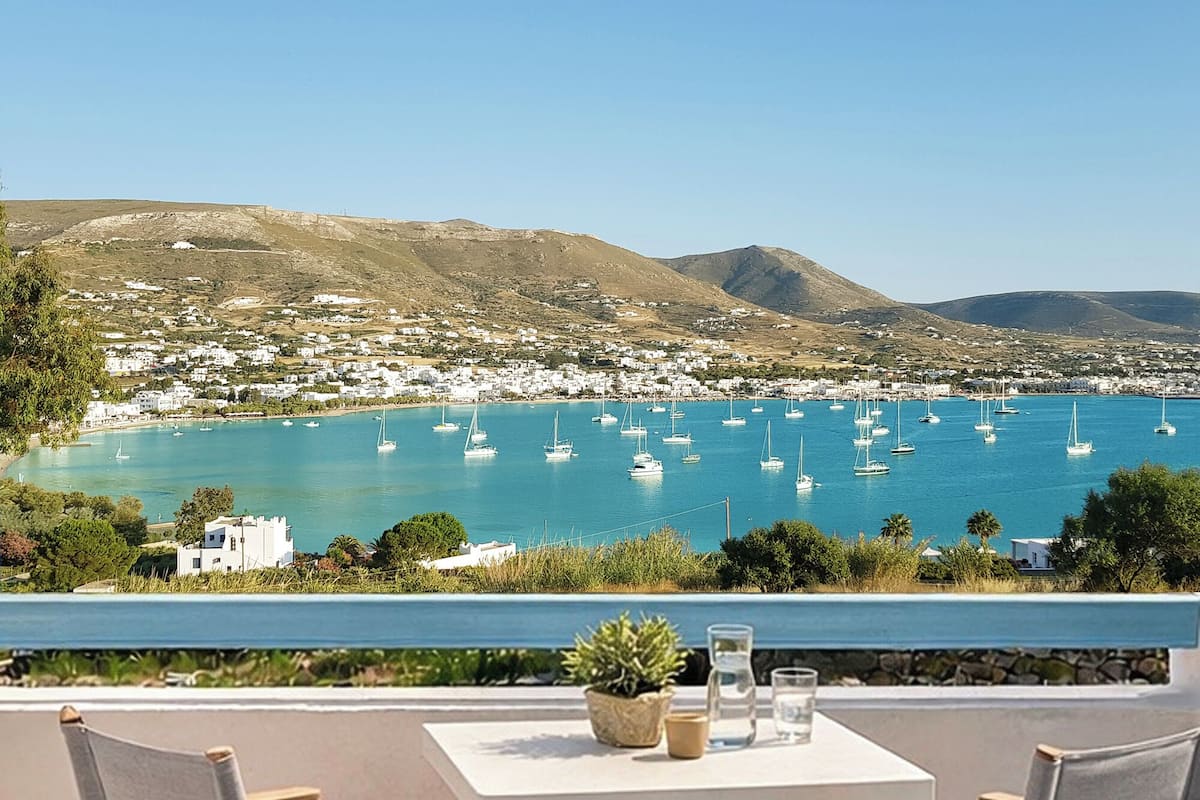 A coastal town with a view of the sea and mountains.