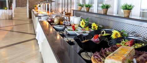 A buffet setup with various dishes and a long counter.