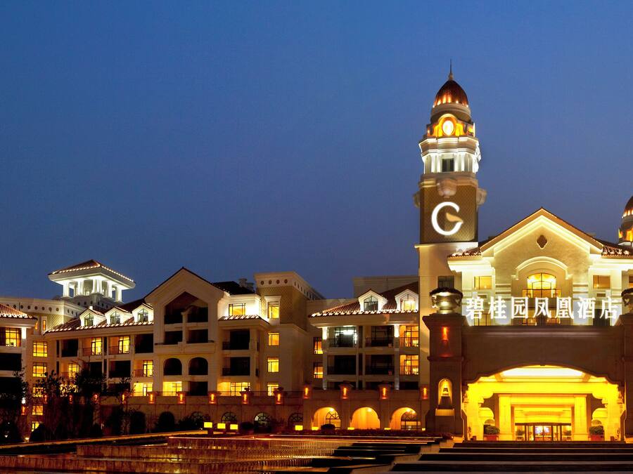 A large, multi-story hotel with a prominent clock tower and a grand entrance.