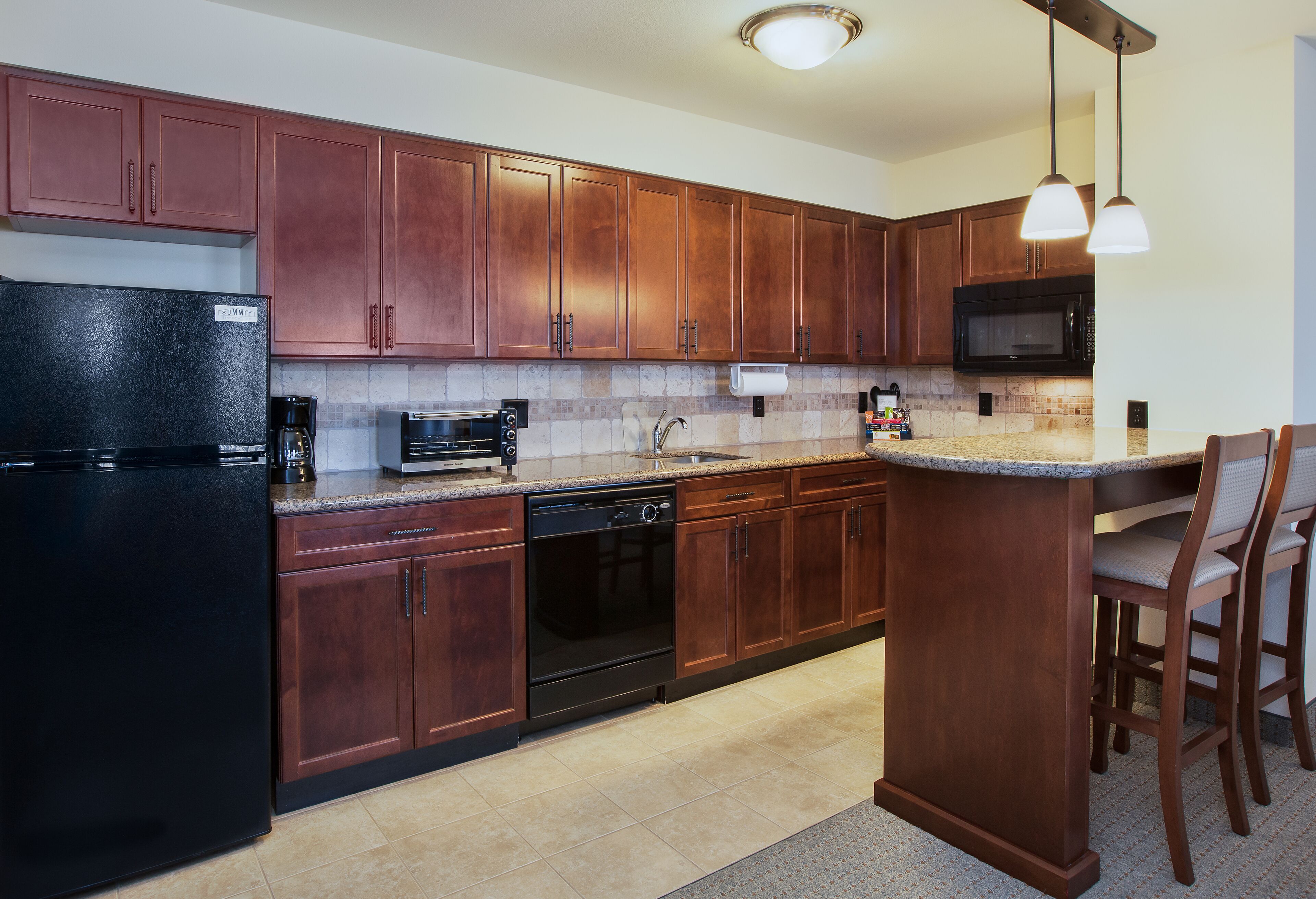 full-sized fridge, microwave, stovetop, dishwasher