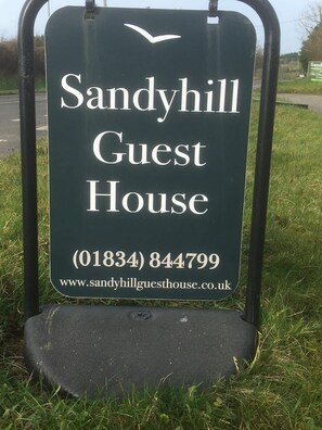 A sign for Sandyhill Guest House with contact information and a website URL. - Sandyhill Guest House (Saundersfoot)