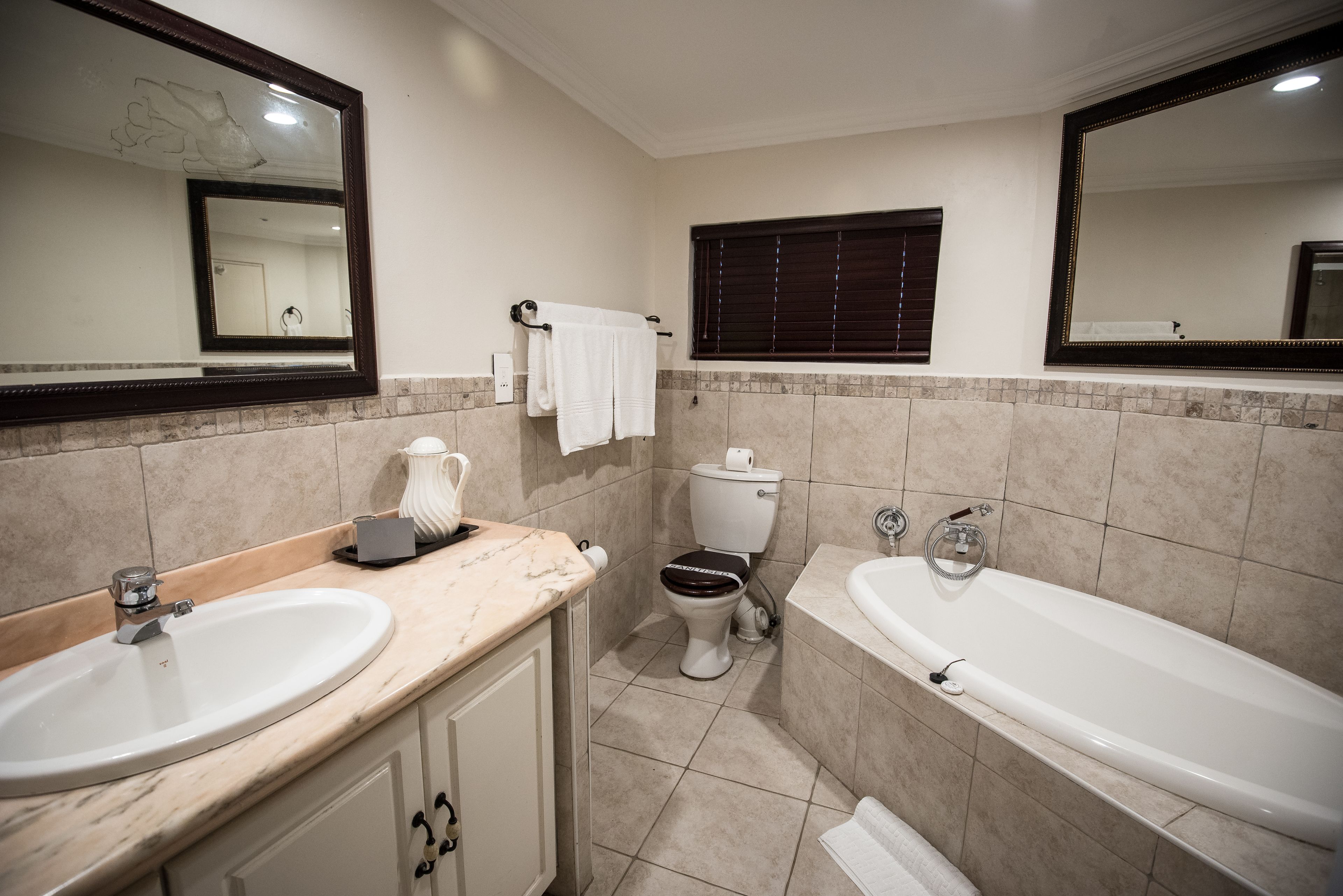A bathroom with a sink, toilet, and bathtub.