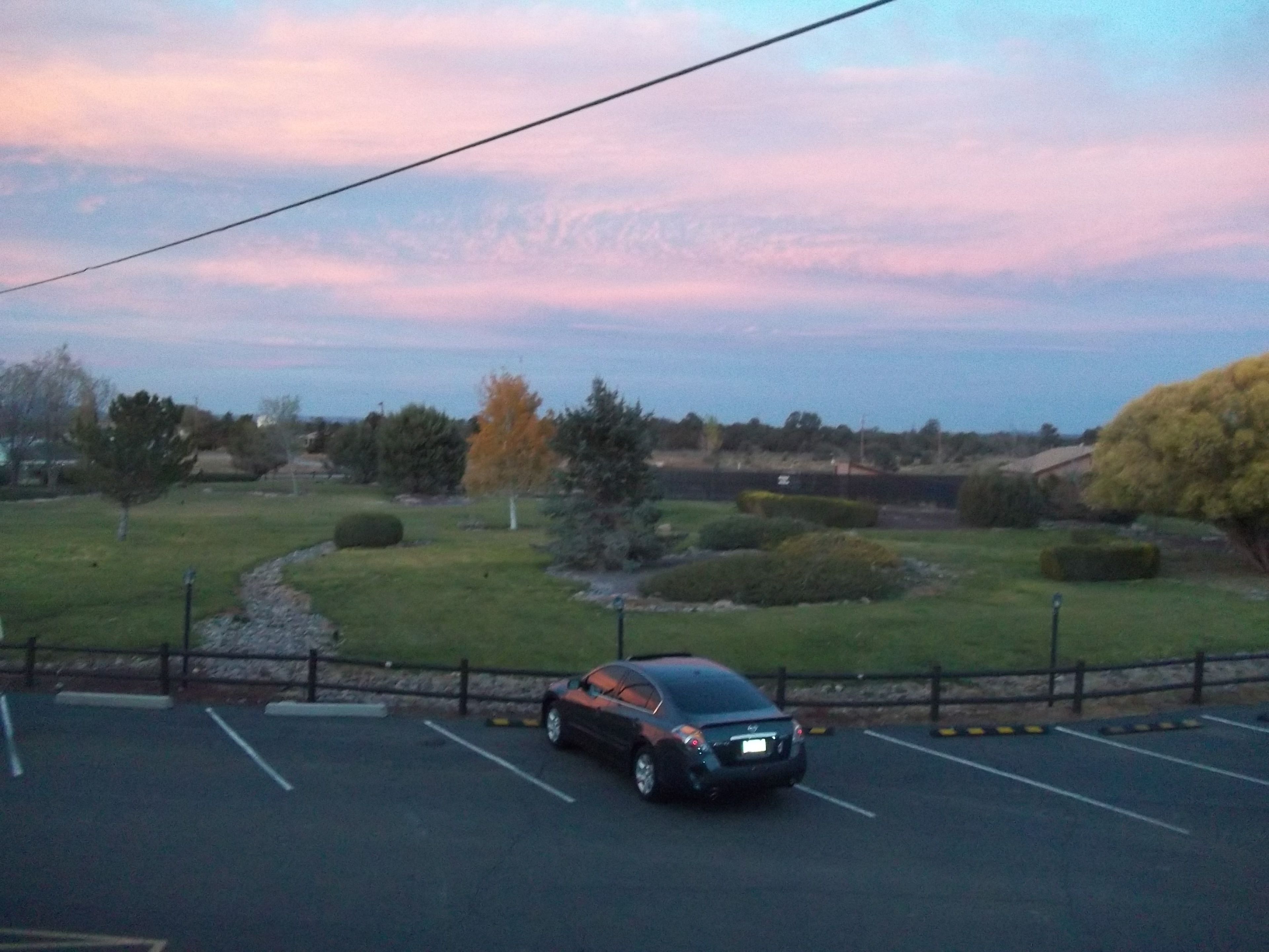 A parking lot with a car parked in a designated space.
