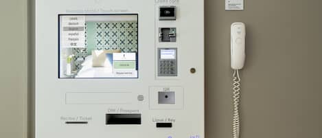 A room service panel with a touch screen interface, payment options, and a keycard reader.
