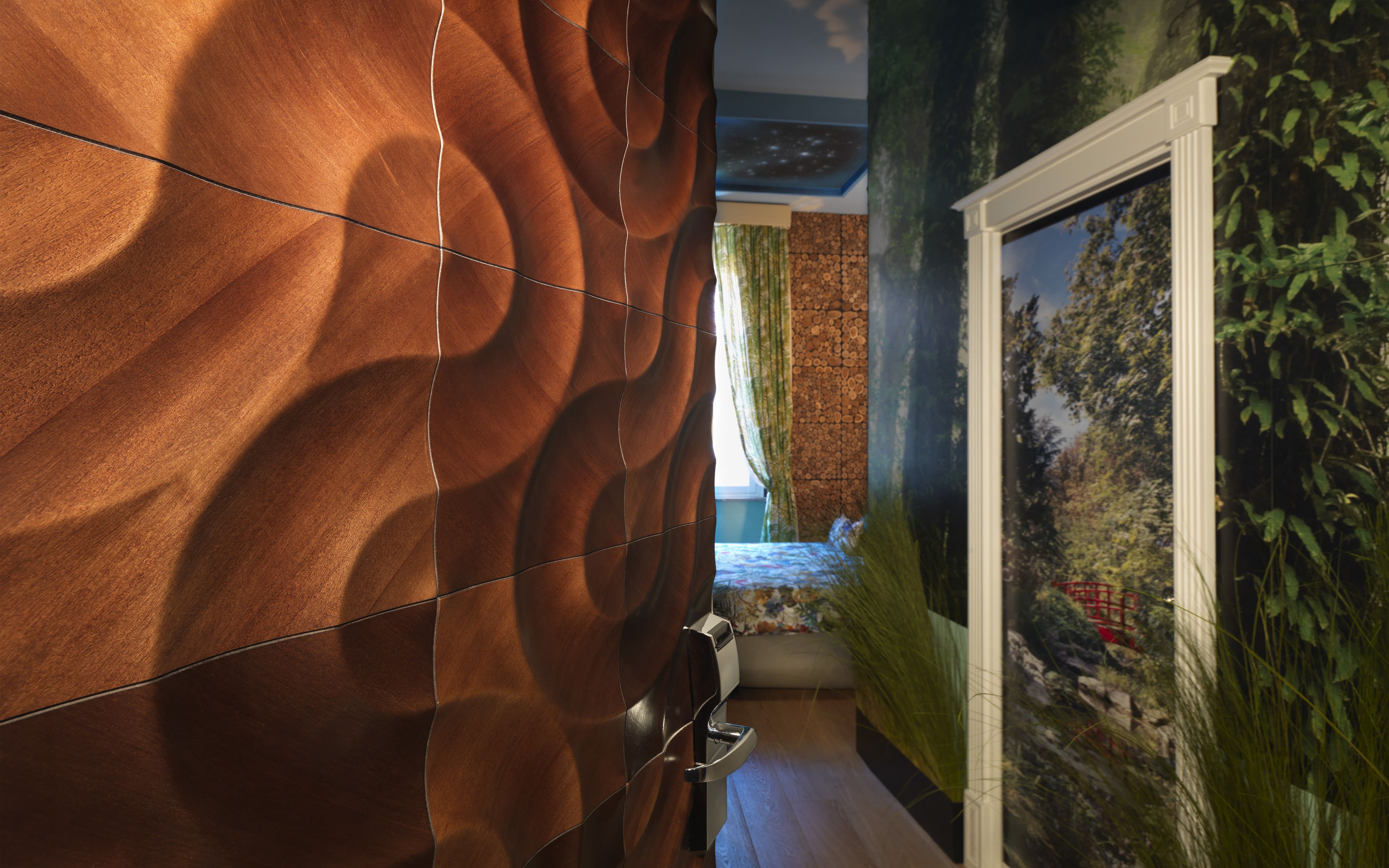 A bathroom with a textured wall, a shower area, and a window with a view of greenery.