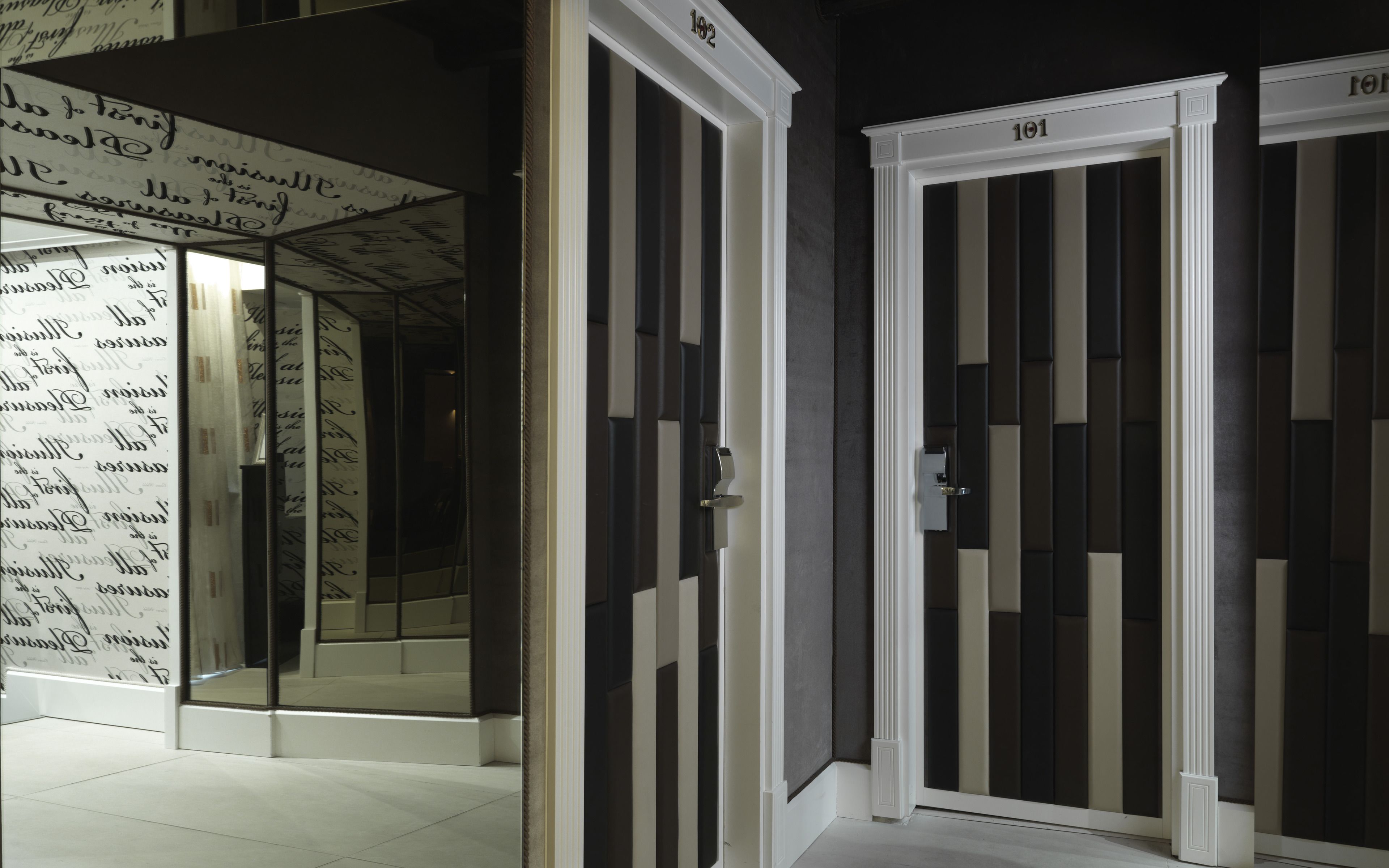 A hallway with doors numbered 101 and 102, leading to rooms.