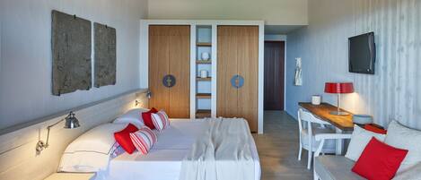 A modern bedroom with a bed, bedside tables, a desk, and a TV.