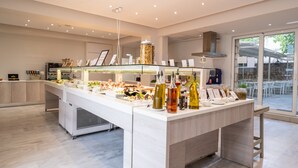 A modern buffet setup with a variety of food items and condiments. - Dimitrios Beach Hotel Adults Friendly 14 plus (Rethymno)