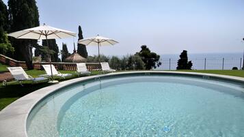 Seasonal outdoor pool, open 10:00 AM to 7:00 PM, pool umbrellas