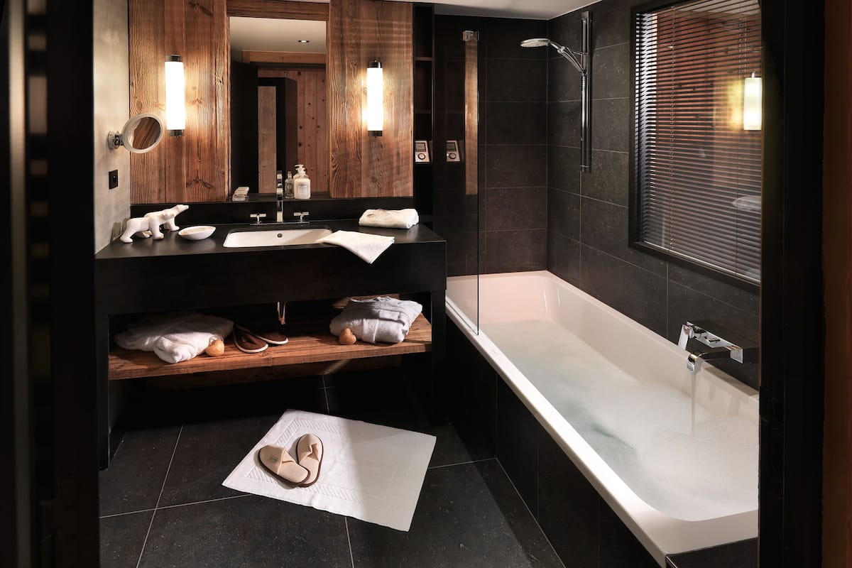 deluxe double room | bathroom | rainfall showerhead, designer toiletries, hair dryer, bathrobes
