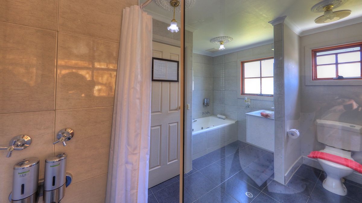 A bathroom with a bathtub, toilet, and sink.