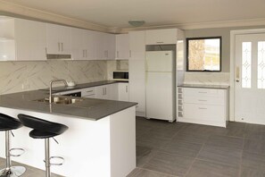 Full-sized fridge, stovetop, coffee/tea maker, electric kettle