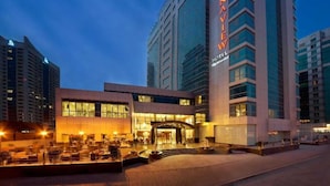 A modern hotel with a prominent 'Marriott' sign, featuring a glass facade and a well-lit entrance. - Sunday Marina View Hotel Apartments (Dubai)