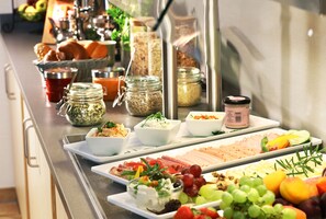 A buffet with various food items and condiments. - JUFA Hotel Pöllau - Self Check-in (Poellau)