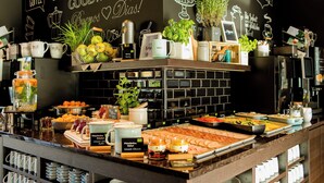 A breakfast buffet with various food items and a coffee station. - Motel One Salzburg-Süd (Salzburg)