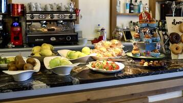 A kitchen counter with various food items and a coffee machine.