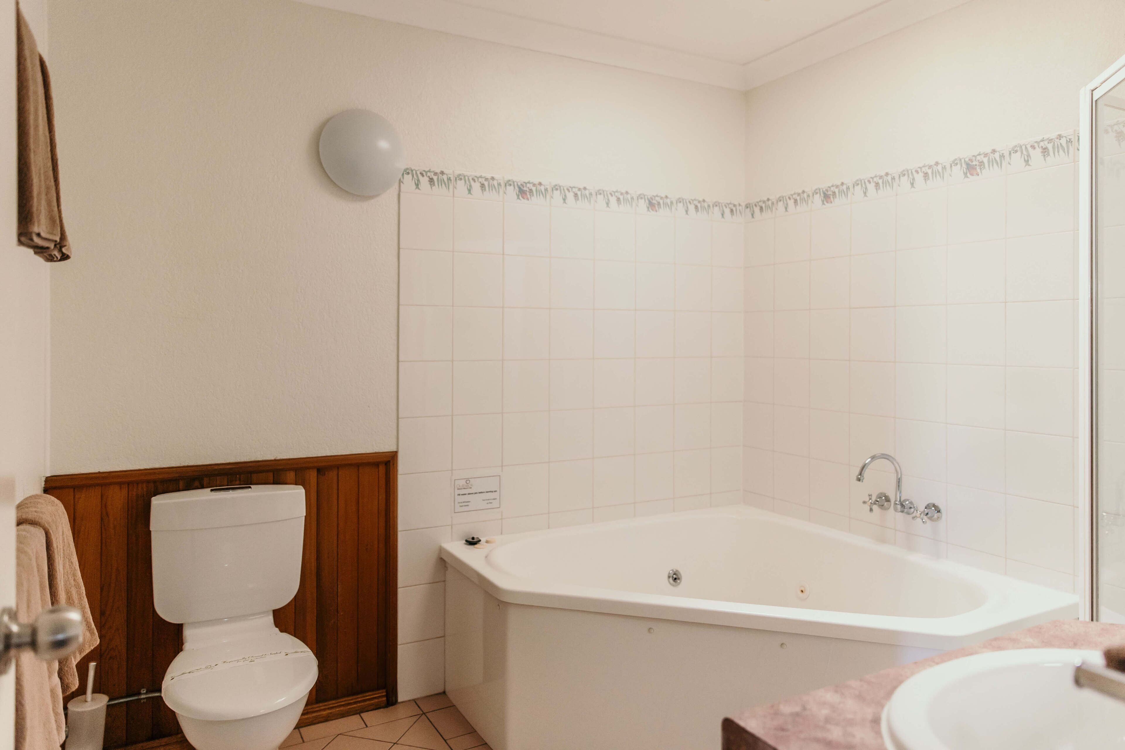 A bathroom with a toilet, a bathtub, and a sink.