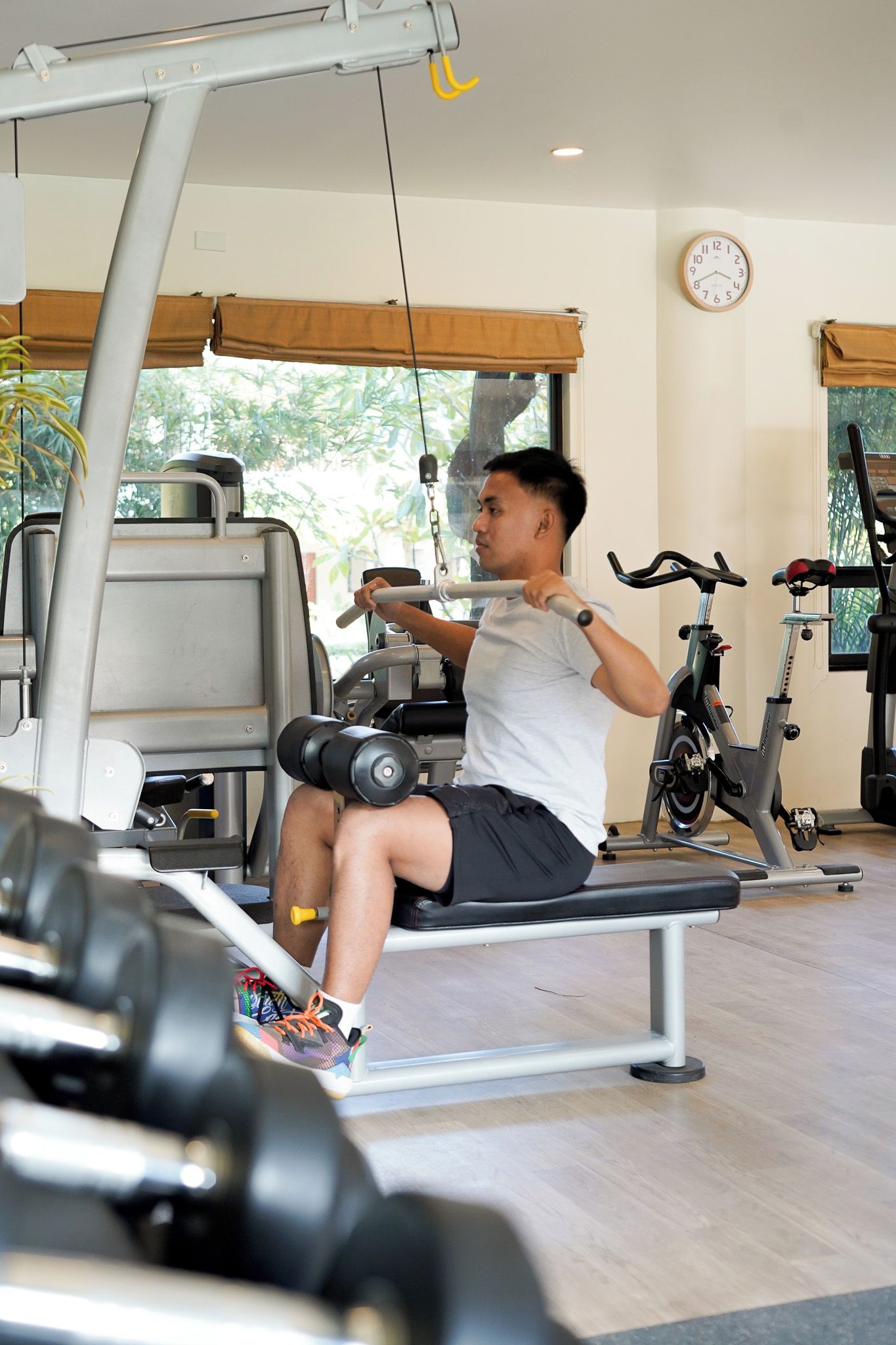 A gym with exercise equipment, a bench, and a bicycle.