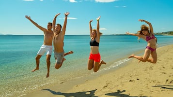 On the beach, sun-loungers, beach umbrellas, beach towels