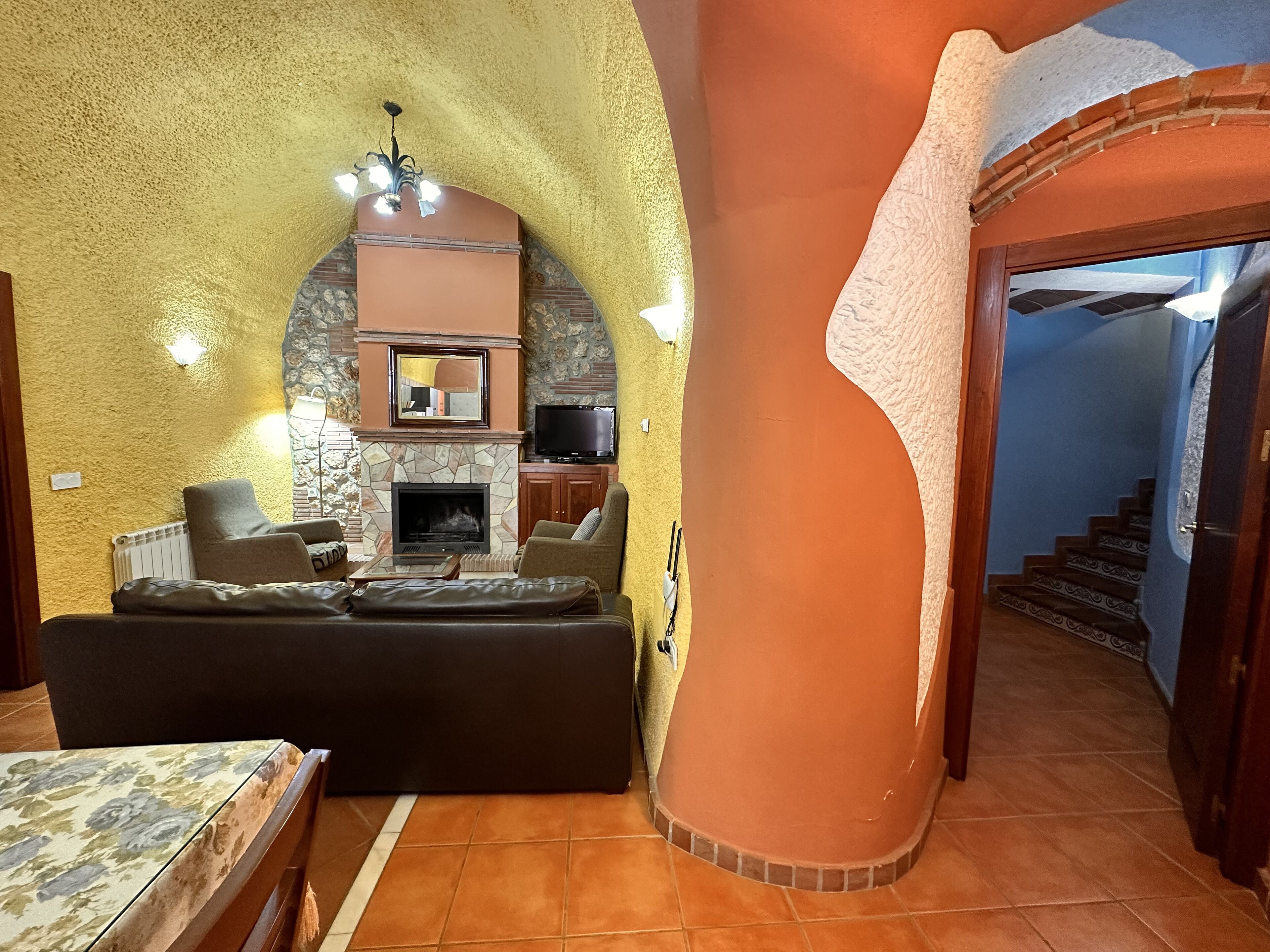 A cozy living area with a fireplace, comfortable seating, and a television.