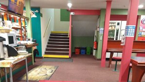 A hotel lobby with a red carpet reading "Quick Palace" and a staircase leading to the upper floor. - Quick Palace Le Mans Nord St Saturnin (Saint-Saturnin)