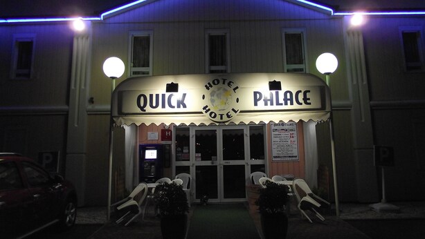 A hotel named 'Quick Palace' with a marquee sign, a parking area, and outdoor seating. - Quick Palace Le Mans Nord St Saturnin (Saint-Saturnin)