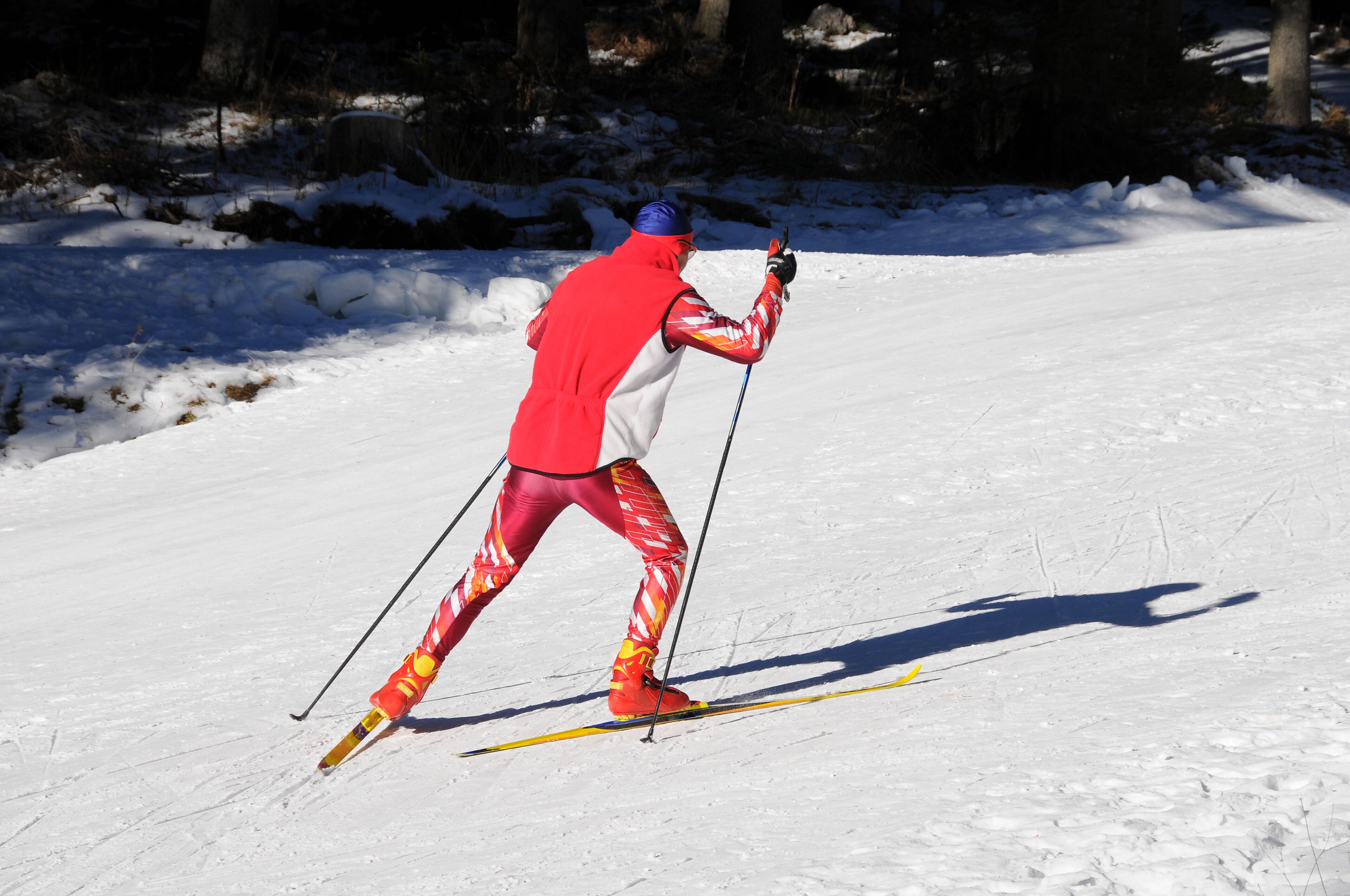 A person cross-country skiing on a snowy path.