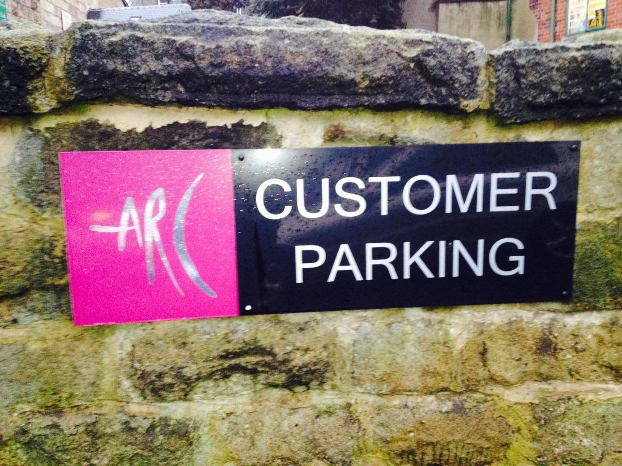 A sign indicating customer parking.