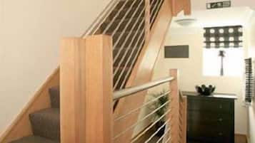 A staircase with wooden steps and metal railings.