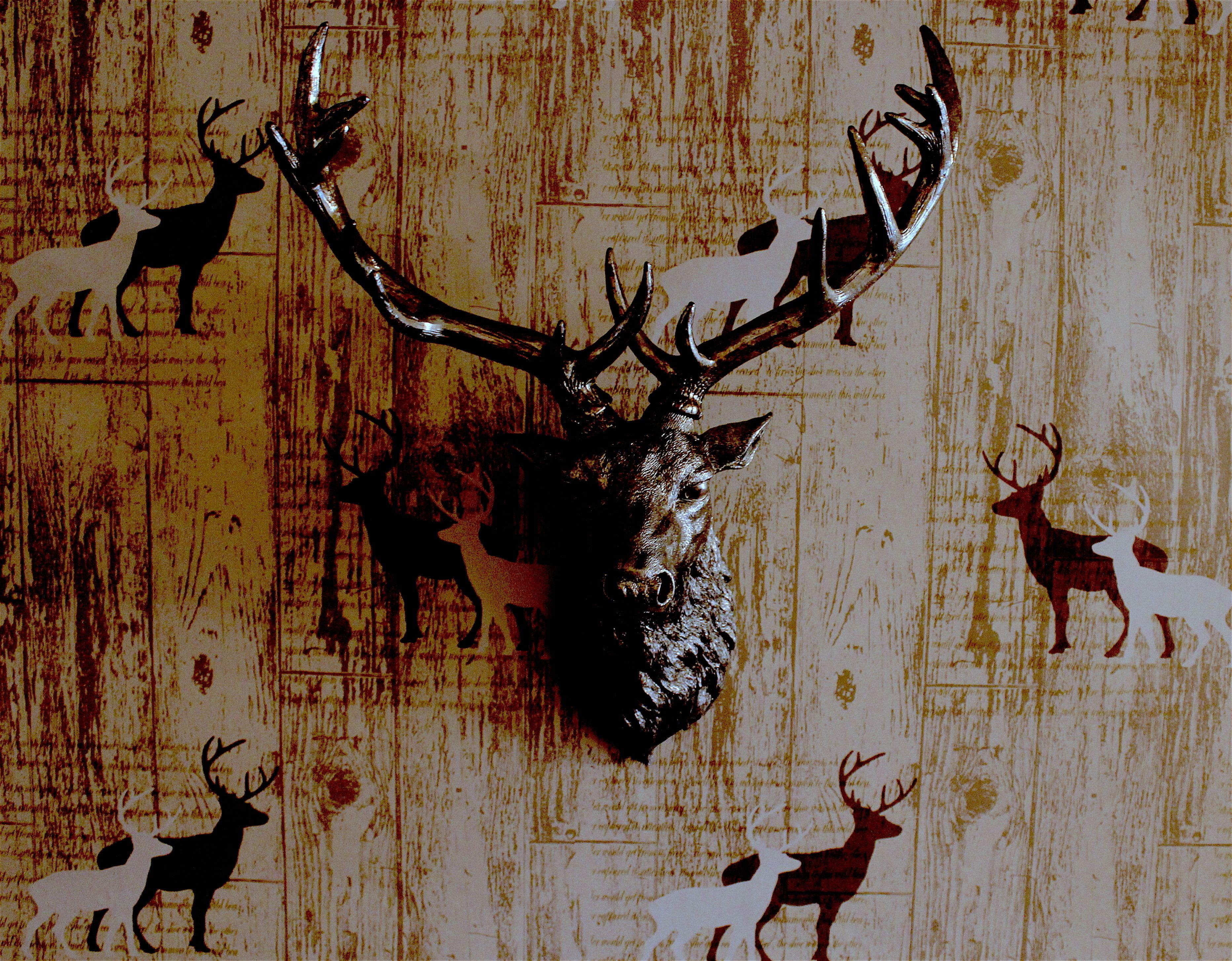 A deer head mounted on a wall with multiple deer silhouettes in the background.