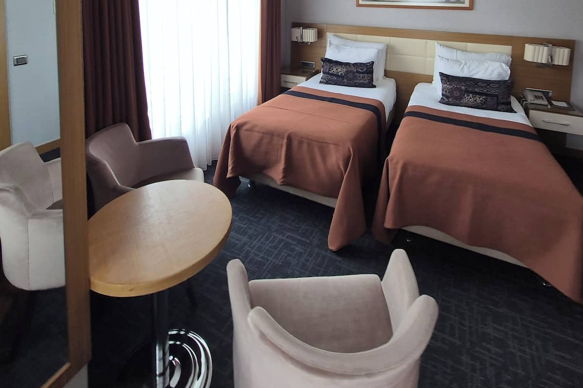 Deluxe Twin Room | Living area | 22-inch LCD TV with cable channels, TV