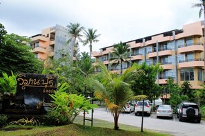 A multi-story hotel with a modern design, featuring balconies and large windows.