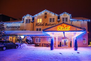 Hotel Batory offers a traditional welcome with a pitched roof and decorative lights.