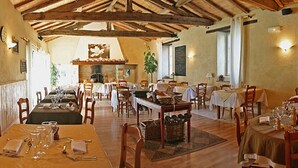 A restaurant with wooden beams, tables set for dining, and chalkboards with menus. - Domaine Le Martinet, The Originals Relais  (Bouin)