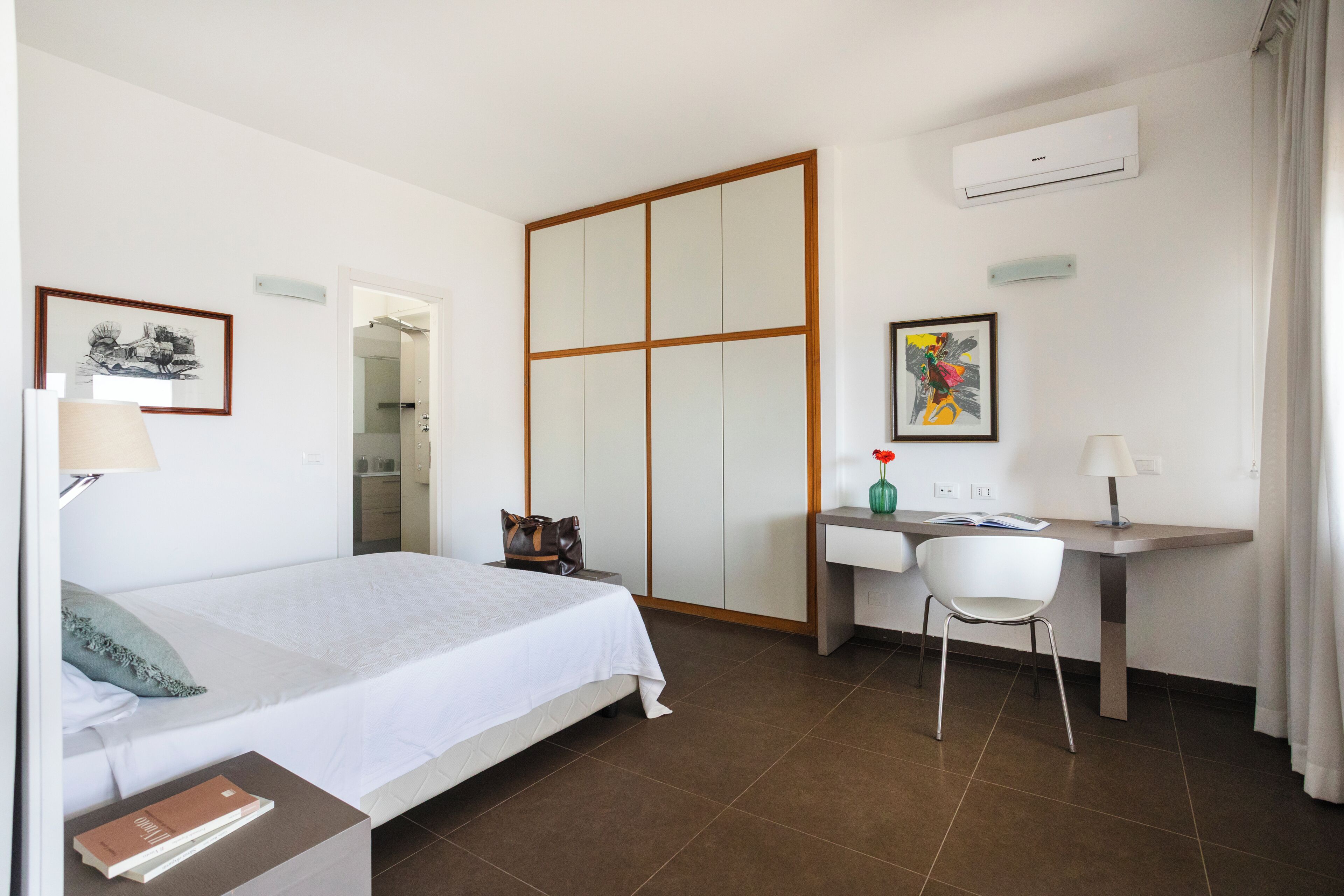 Une chambre d’hôtel équipée d’un lit, d’un bureau, d’une chaise et d’une armoire.
