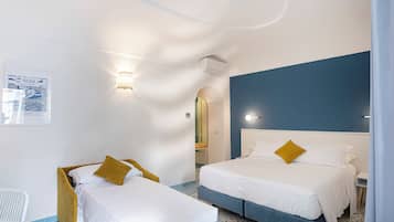 Triple Room | Minibar, in-room safe, individually decorated, individually furnished
