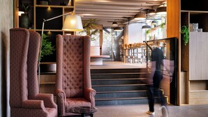 Un interior moderno con una escalera, una zona de estar y un bar.