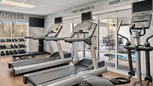 A gym with treadmills, dumbbells, and a pool view. - Fairfield Inn & Suites by Marriott Paducah (Paducah)