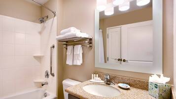A bathroom with a bathtub, a sink with a mirror, and a towel rack.